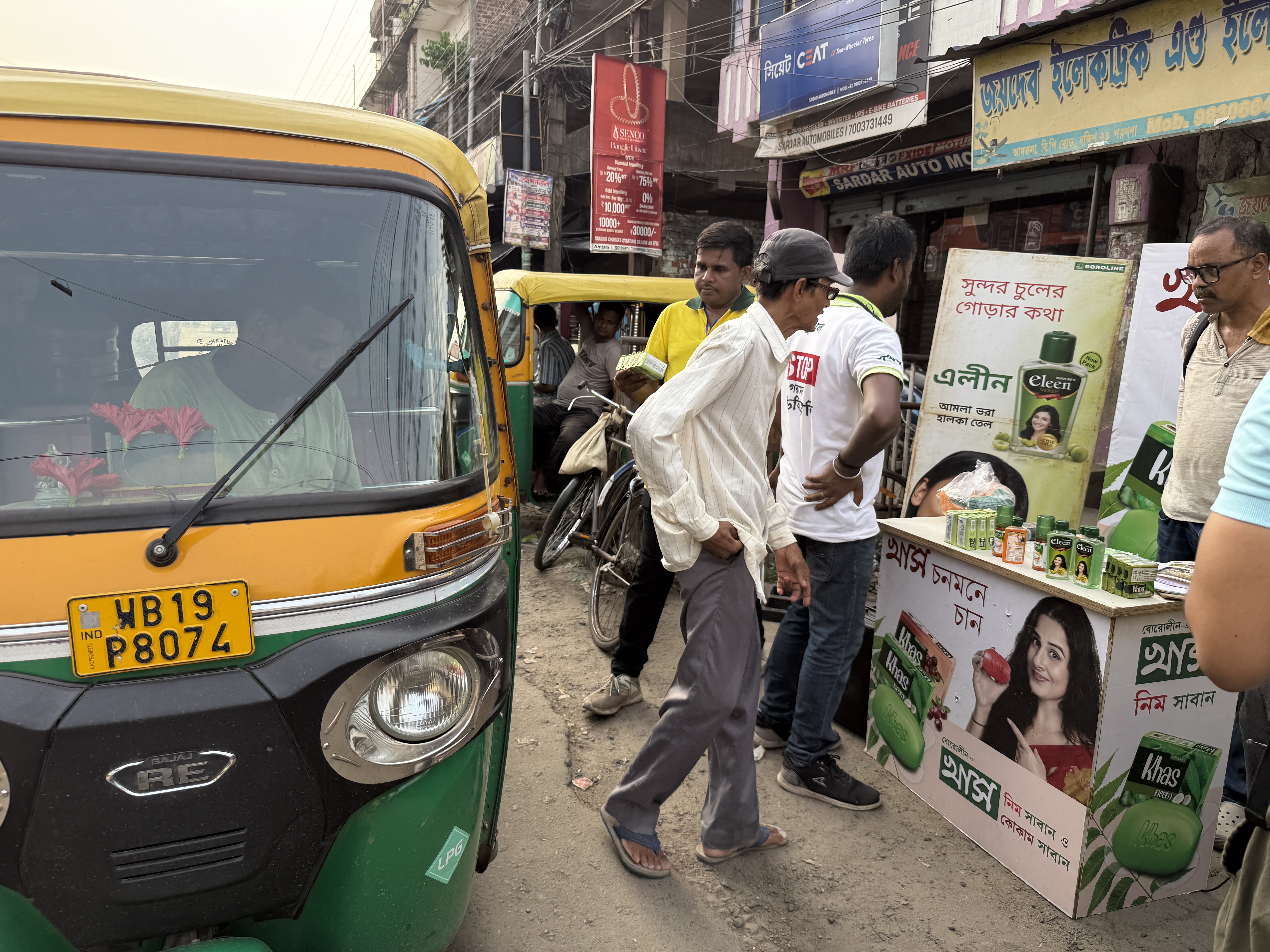 Rural brand activation stall at a market intersection in South 24 Parganas, West Bengal — sampling and trial sales programme