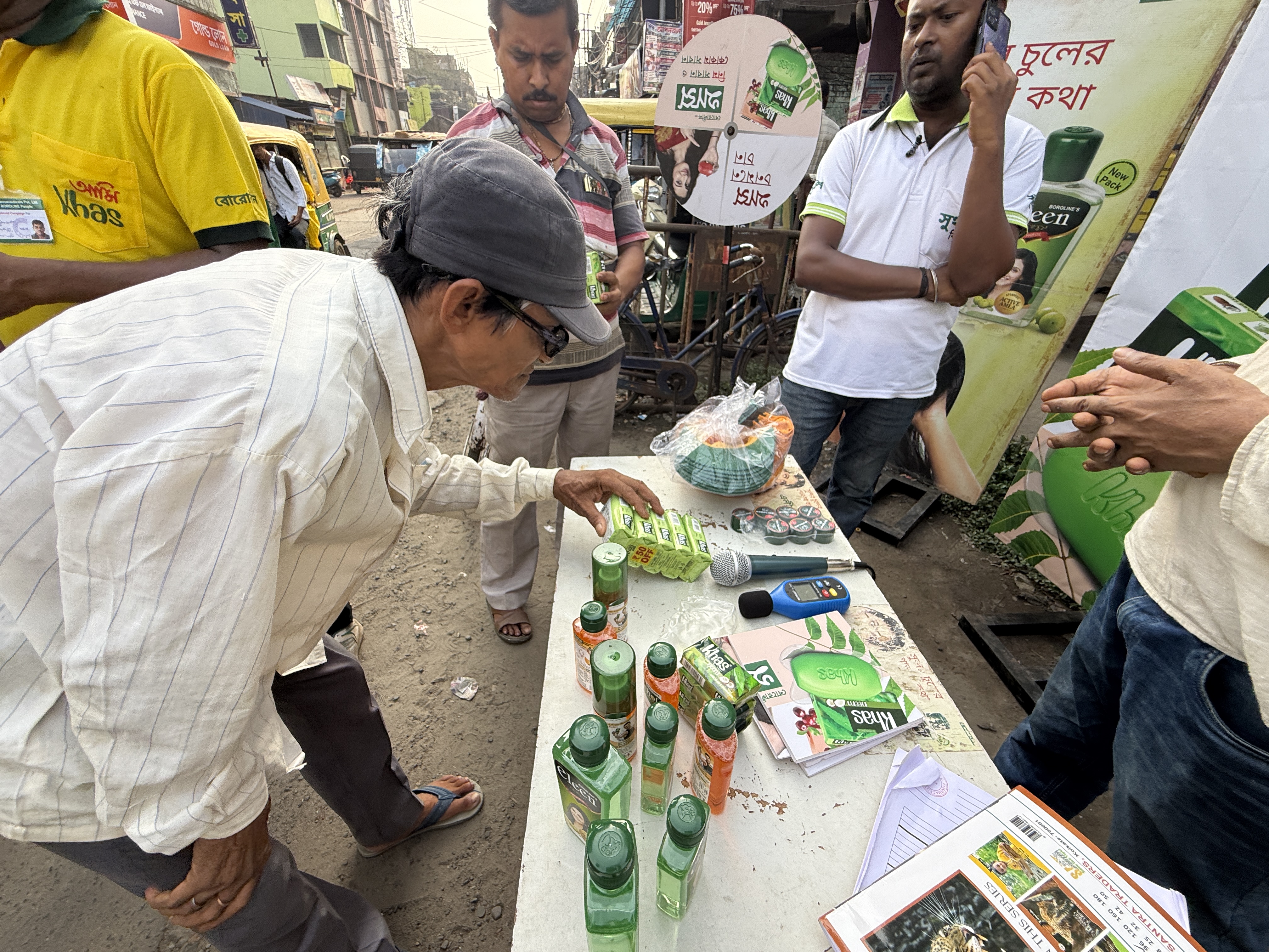 Consumer examining product packaging at Boroline Khas activation stall