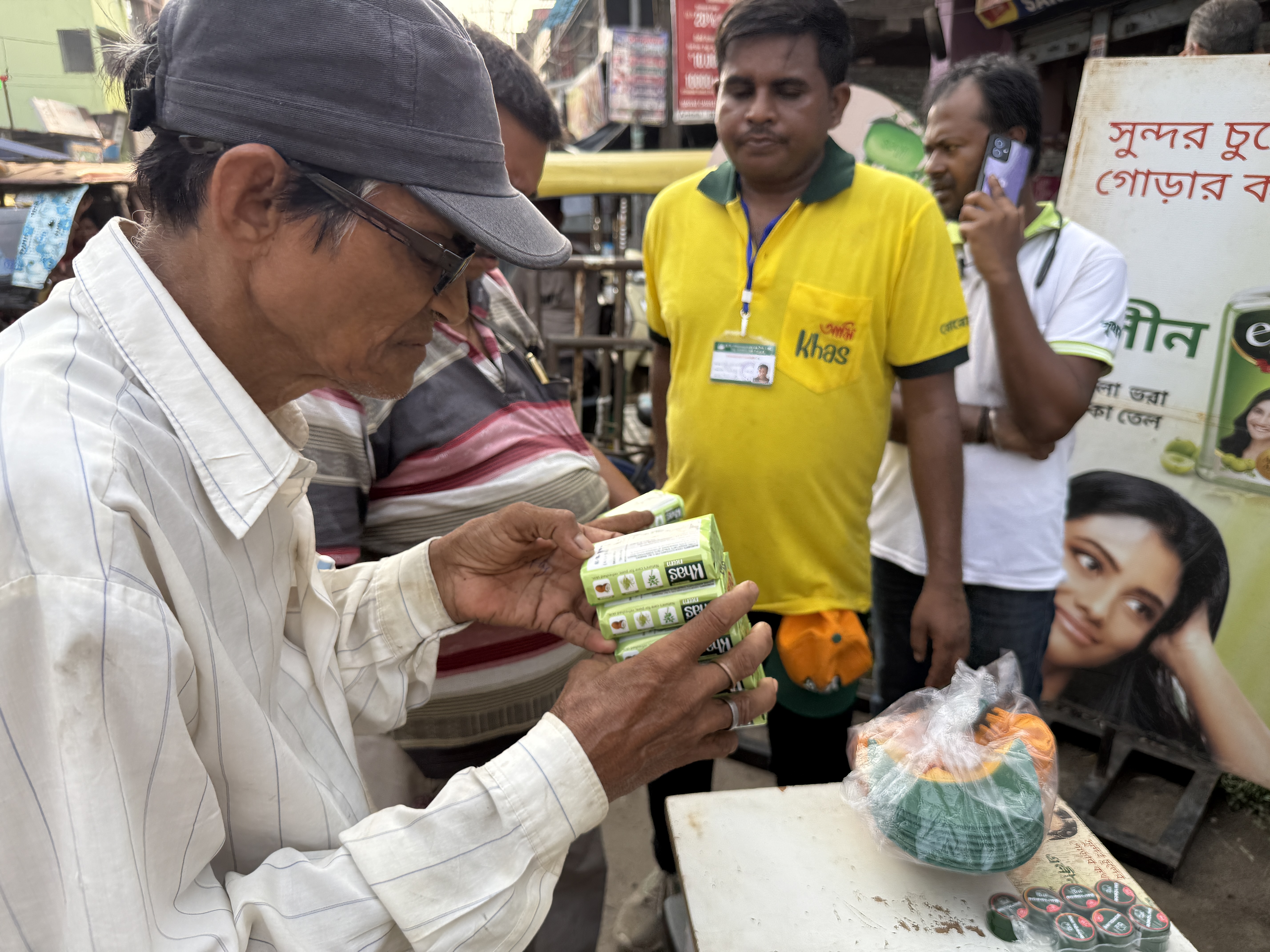 Rural consumer reading product label carefully at activation stall