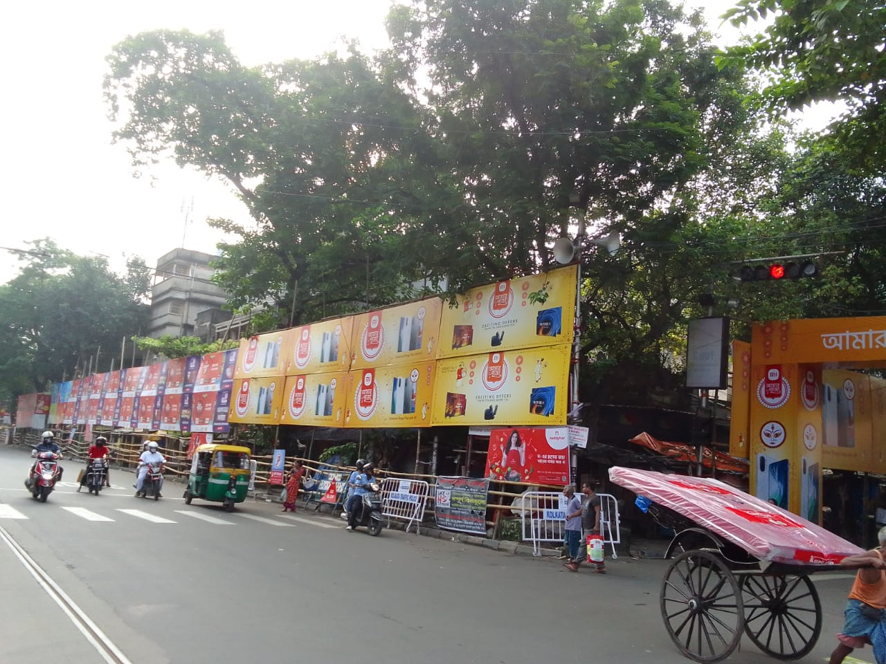 Festive brand hoardings and outdoor media along Kolkata streets during Durga Puja season