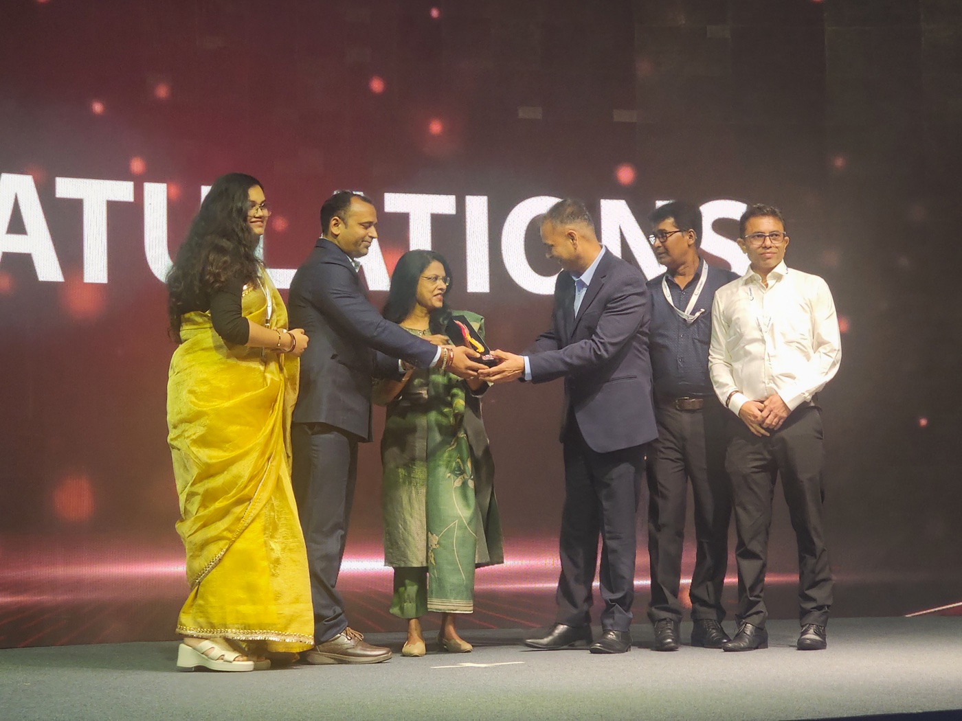COMCRAFT receiving the Gold Award on stage at RMAI FLAME Awards Asia 2026