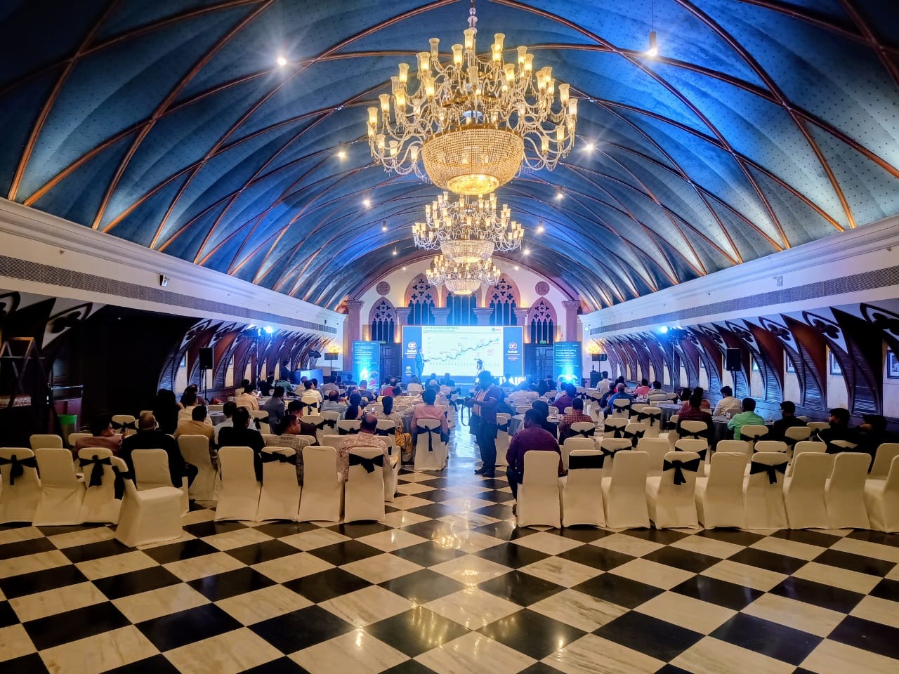 Corporate conference — heritage vaulted hall, blue lighting