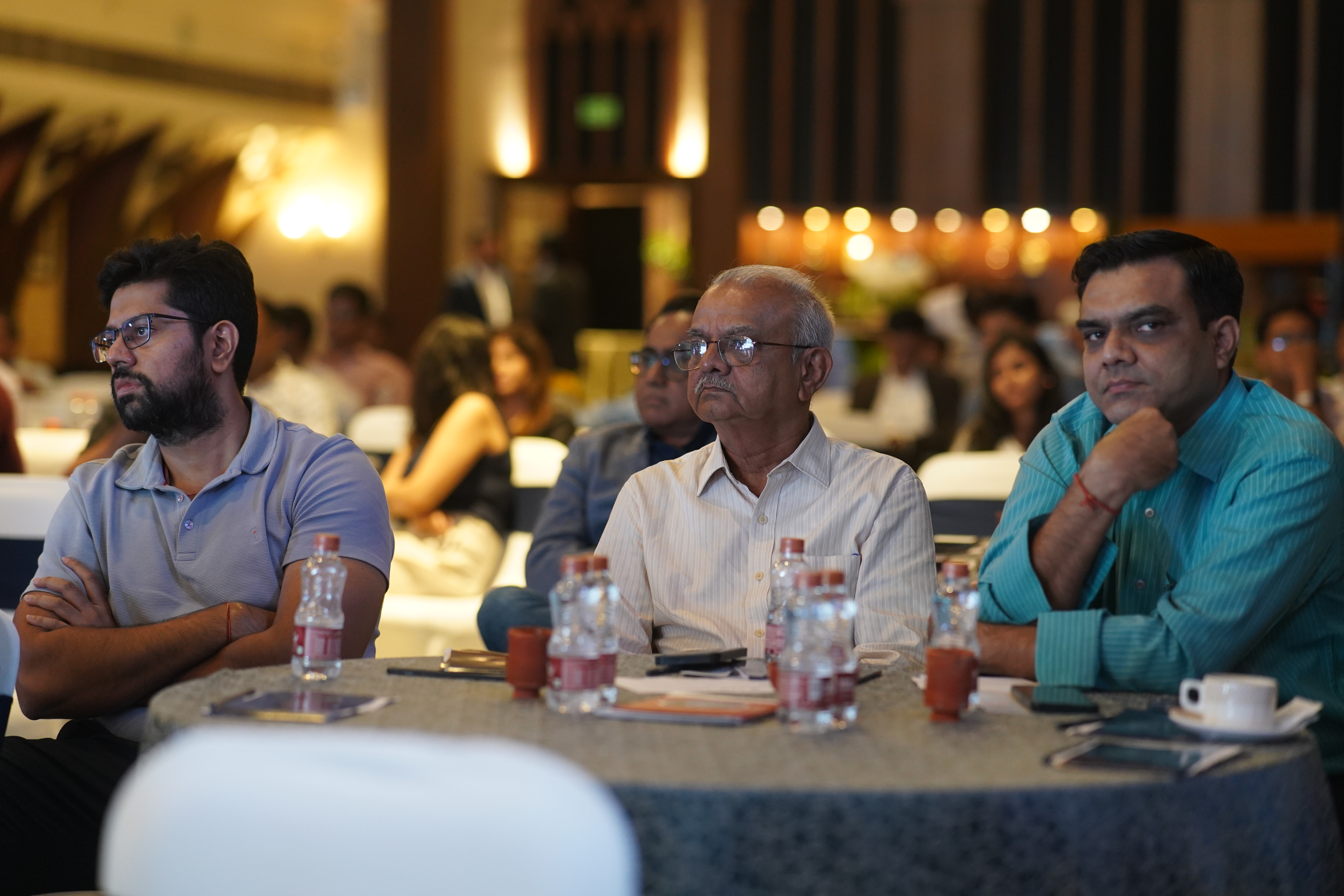 Conference delegates at round tables — ballroom setting