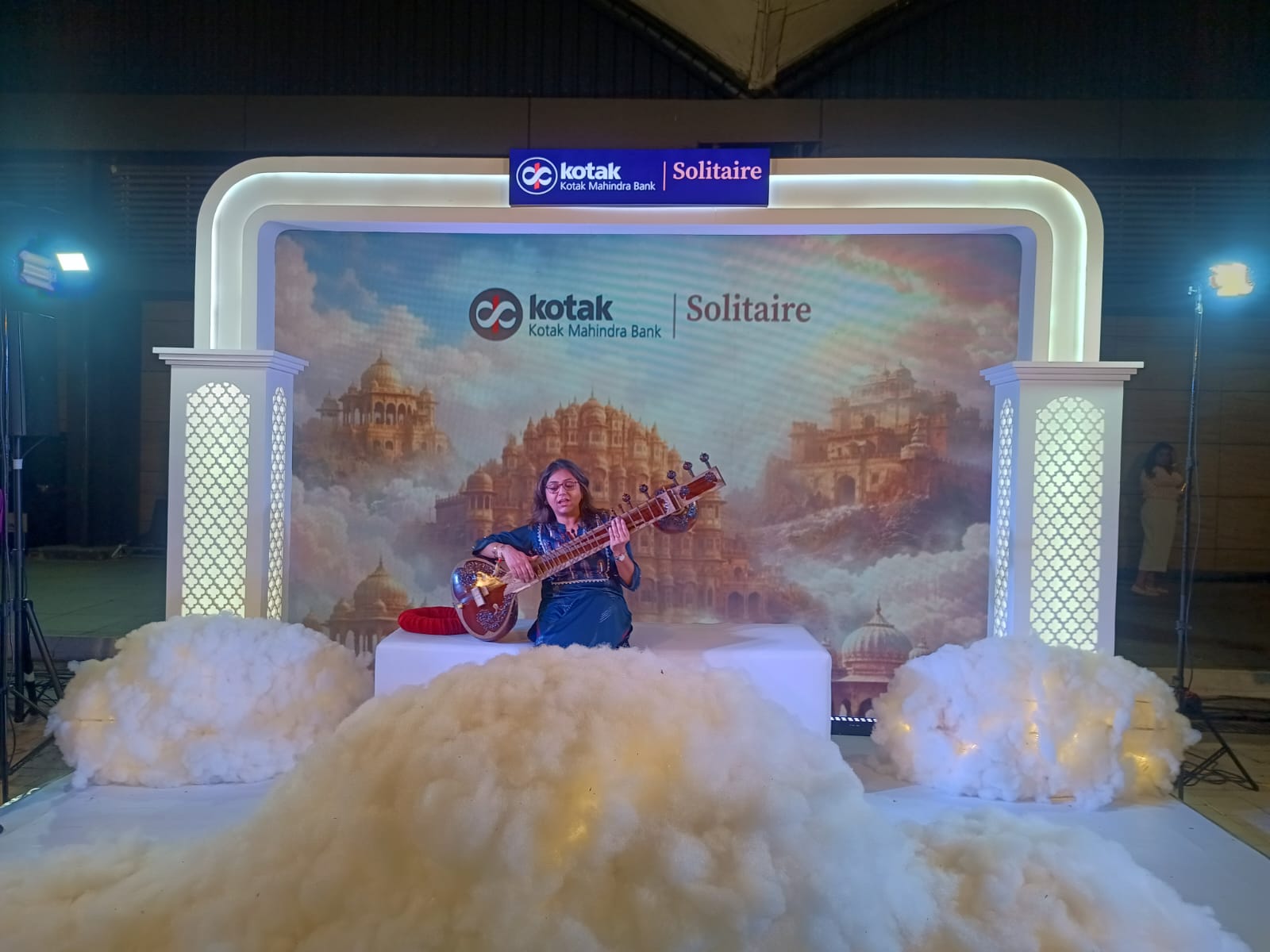 Kotak Solitaire branded stage — palace backdrop, sitar performer
